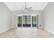 Living area with neutral color walls and sliding door to a screen enclosed porch at 6384 Draw Ln # 38, Sarasota, FL 34238