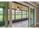 Screened porch with view of the yard at 6384 Draw Ln # 38, Sarasota, FL 34238