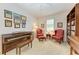 Spacious home office with piano, comfortable seating, and bookshelves at 12105 Goldenrod Ave, Bradenton, FL 34212