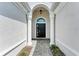 Elegant entryway with arched columns and a black front door at 12105 Goldenrod Ave, Bradenton, FL 34212
