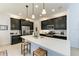 Modern kitchen with dark cabinetry, quartz countertops, and island at 12105 Goldenrod Ave, Bradenton, FL 34212