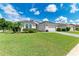 One-story home with a two-car garage and lush landscaping at 12105 Goldenrod Ave, Bradenton, FL 34212