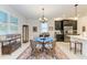 Charming breakfast nook with glass table and four chairs, adjacent to kitchen at 12105 Goldenrod Ave, Bradenton, FL 34212
