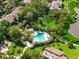 Community pool with surrounding landscaping at 1520 Pelican Point Dr # 251, Sarasota, FL 34231