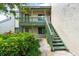 Exterior view showing building entrance and green landscaping at 1520 Pelican Point Dr # 251, Sarasota, FL 34231