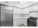 Modern white kitchen with stainless steel appliances at 1520 Pelican Point Dr # 251, Sarasota, FL 34231