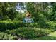 Pelican Cove community entrance sign surrounded by vibrant landscaping at 1520 Pelican Point Dr # 251, Sarasota, FL 34231