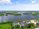 Aerial view of waterfront property with lush landscaping at 1520 Pelican Point Dr # 251, Sarasota, FL 34231