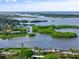 Aerial view of waterfront property with lush landscaping and community at 1520 Pelican Point Dr # 251, Sarasota, FL 34231