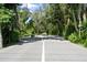 Gated community entrance with a paved road leading into the neighborhood at 1520 Pelican Point Dr # 251, Sarasota, FL 34231