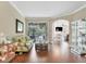 Bright living room with hardwood floors, floral sofa, and views of the pool at 3165 Stokie Ave, North Port, FL 34286