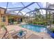 Screened-in pool and patio with seating and a water feature at 3165 Stokie Ave, North Port, FL 34286