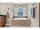 Bathroom featuring a large garden tub and window at 3165 Stokie Ave, North Port, FL 34286
