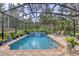 Relaxing screened-in pool and patio area with water feature at 3165 Stokie Ave, North Port, FL 34286