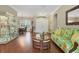 Living room with hardwood floors, floral sofa, and view of dining area at 3165 Stokie Ave, North Port, FL 34286