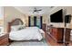 Bright main bedroom with a king-size bed and large TV at 3165 Stokie Ave, North Port, FL 34286