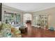 Bright living room with hardwood floors, floral sofa, and views of the pool at 3165 Stokie Ave, North Port, FL 34286