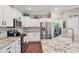 Kitchen with white cabinets, granite counters, and stainless steel appliances at 3165 Stokie Ave, North Port, FL 34286