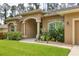 House exterior with teal door and manicured landscaping at 3165 Stokie Ave, North Port, FL 34286