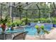 Inviting pool area with a waterfall feature and plenty of plants at 3165 Stokie Ave, North Port, FL 34286