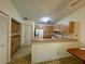 Kitchen with light wood cabinets, refrigerator, stove and breakfast bar at 3925 Oakhurst Blvd # 3010, Sarasota, FL 34233