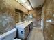 Bathroom with single vanity, tub, and floral wallpaper at 3925 Oakhurst Blvd # 3010, Sarasota, FL 34233