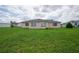 Large backyard with green grass and home view at 13592 Clara Ln, Port Charlotte, FL 33981