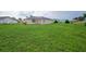Large backyard with green grass and home view at 13592 Clara Ln, Port Charlotte, FL 33981