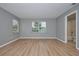 Bedroom with bathroom access and wood-look floors at 13592 Clara Ln, Port Charlotte, FL 33981