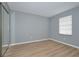 Bright bedroom with mirrored closet and laminate wood floor at 13592 Clara Ln, Port Charlotte, FL 33981