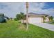 House exterior with attached garage and driveway at 13592 Clara Ln, Port Charlotte, FL 33981