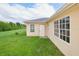 Tan house exterior with white windows and door at 13592 Clara Ln, Port Charlotte, FL 33981