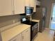 Modern kitchen with stainless steel appliances and white cabinets at 13592 Clara Ln, Port Charlotte, FL 33981