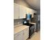 Modern kitchen with stainless steel appliances and white cabinets at 13592 Clara Ln, Port Charlotte, FL 33981