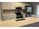 Modern kitchen with stainless steel appliances and white cabinets at 13592 Clara Ln, Port Charlotte, FL 33981