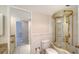 Bathroom featuring vanity, toilet, and whirlpool tub with glass enclosure at 1945 Gulf Of Mexico Dr # M2-310, Longboat Key, FL 34228