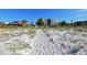 View of community from sandy path leading to a white sand beach at 1945 Gulf Of Mexico Dr # M2-310, Longboat Key, FL 34228