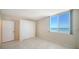 Bright bedroom featuring a closet and a window with ocean views at 1945 Gulf Of Mexico Dr # M2-310, Longboat Key, FL 34228