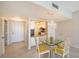 A dining area features a glass table and leads into the kitchen with white cabinets at 1945 Gulf Of Mexico Dr # M2-310, Longboat Key, FL 34228