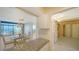 Open-concept dining area with chandelier and balcony access overlooking ocean views at 1945 Gulf Of Mexico Dr # M2-310, Longboat Key, FL 34228