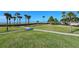 Beautifully landscaped grounds with walking path, palm trees, and ocean views at 1945 Gulf Of Mexico Dr # M2-310, Longboat Key, FL 34228