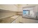 This bright kitchen features white cabinets, stone countertops, and a pass-through to the dining area at 1945 Gulf Of Mexico Dr # M2-310, Longboat Key, FL 34228