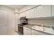 This is a kitchen area with white cabinets, granite countertops, and stainless steel appliances at 1945 Gulf Of Mexico Dr # M2-310, Longboat Key, FL 34228