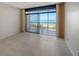Bright living room featuring floor-to-ceiling sliding glass doors leading to a balcony with ocean views at 1945 Gulf Of Mexico Dr # M2-310, Longboat Key, FL 34228