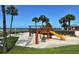 A charming outdoor playground featuring a slide, swings and climbing wall with ocean views at 1945 Gulf Of Mexico Dr # M2-310, Longboat Key, FL 34228