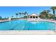 A sprawling swimming pool with clear blue water and plenty of lounge chairs and umbrellas at 1945 Gulf Of Mexico Dr # M2-310, Longboat Key, FL 34228
