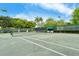 Well-maintained community tennis court with lush green surroundings and ample space at 1945 Gulf Of Mexico Dr # M2-310, Longboat Key, FL 34228