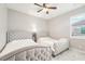 Spacious bedroom with two twin beds, ceiling fan, and neutral decor at 332 Mccabe St, Port Charlotte, FL 33953