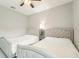 Spacious bedroom with two twin beds, ceiling fan, and neutral decor at 332 Mccabe St, Port Charlotte, FL 33953