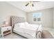 Spacious bedroom with a tufted headboard, large windows, and white bedding at 332 Mccabe St, Port Charlotte, FL 33953